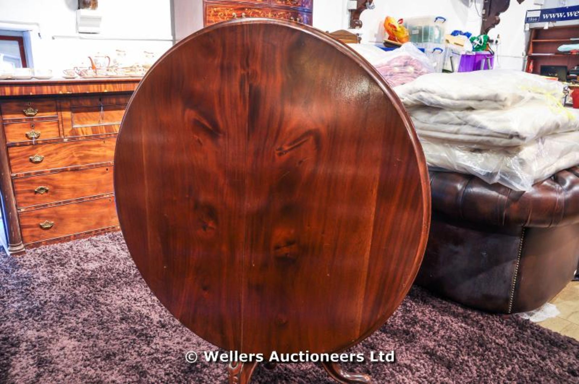 A mahogany tilt top table sitting on turned pedestal with carved tripod legs and original castors, - Image 8 of 8
