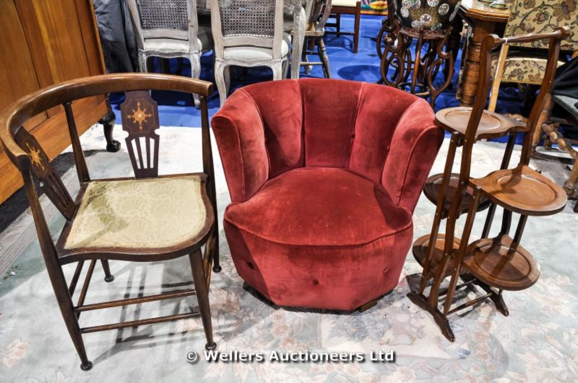 A red velvet covered tub chair, C1930, together with an inlaid corner chair and a five shelf folding