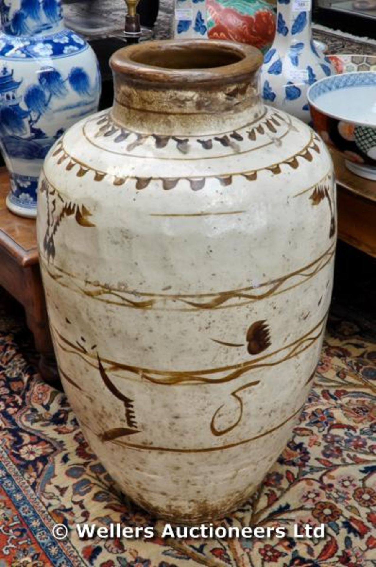 A large Chinese Cizhou (Tz`u-chou) pottery storage jar, oviform painted in brown slip, 65cm