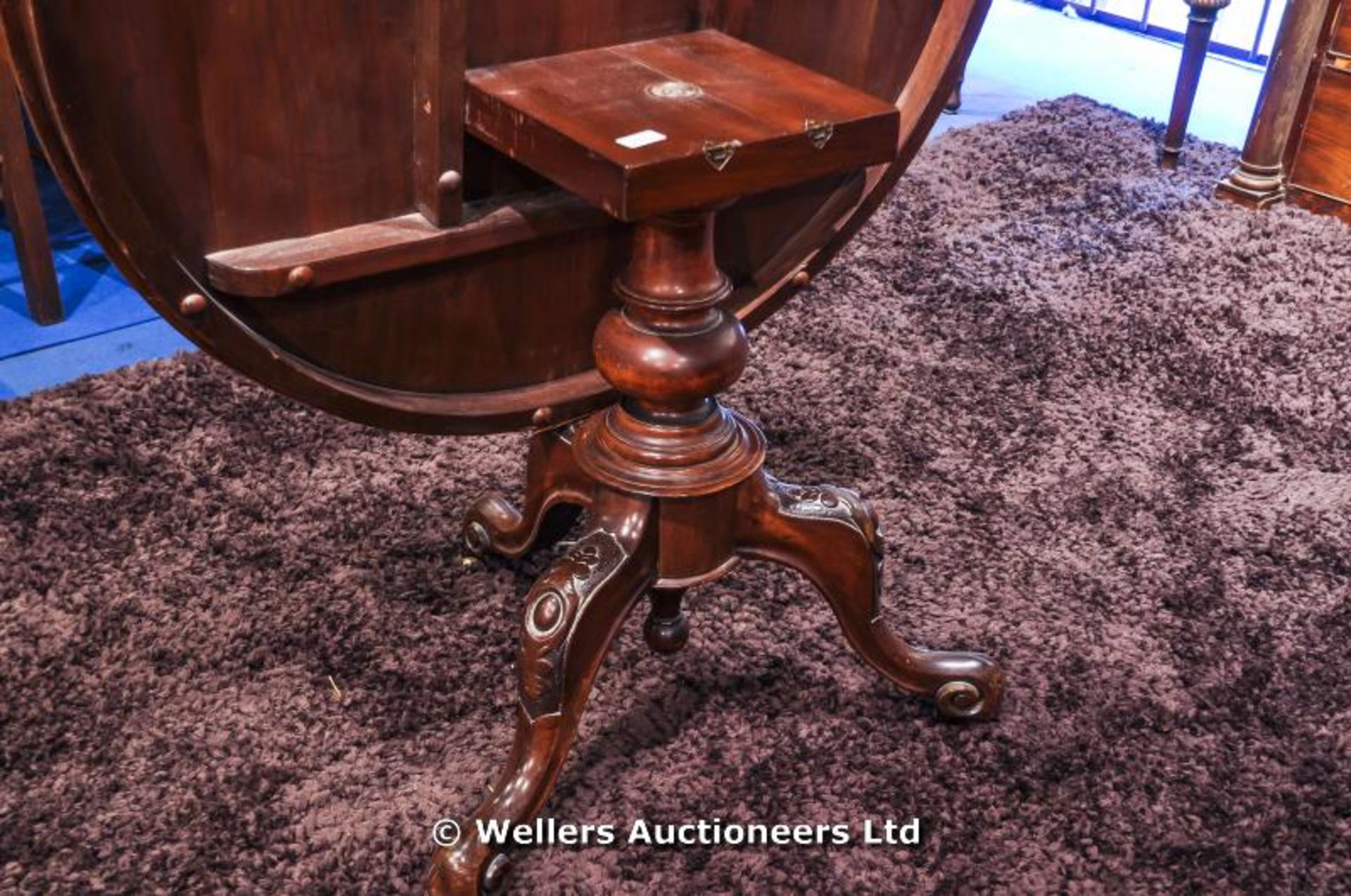 A mahogany tilt top table sitting on turned pedestal with carved tripod legs and original castors, - Image 6 of 8