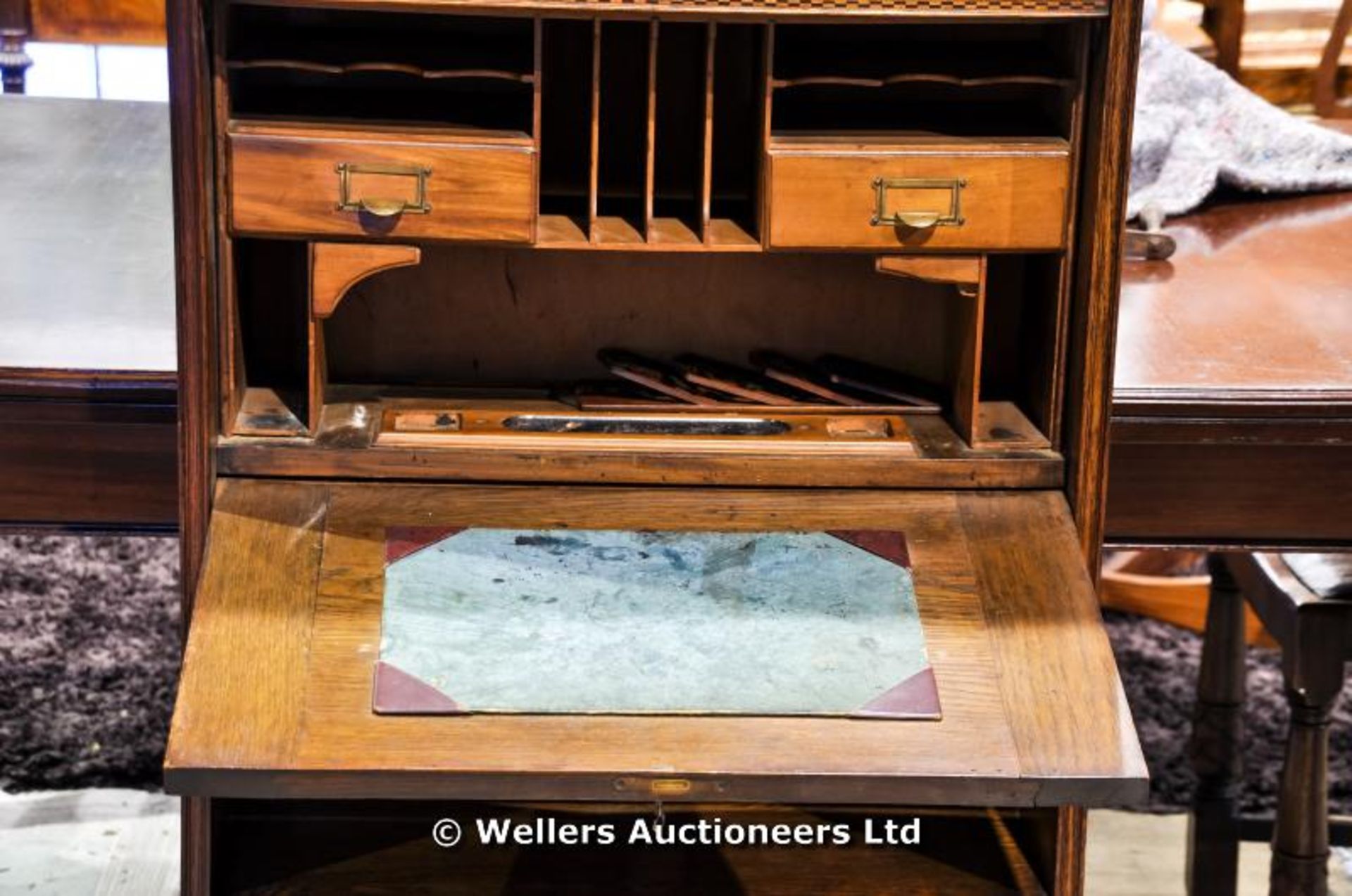 An Arts & Crafts oak bureau bookcase with curtained and glazed upper cupboard, above fully fitted - Image 3 of 4