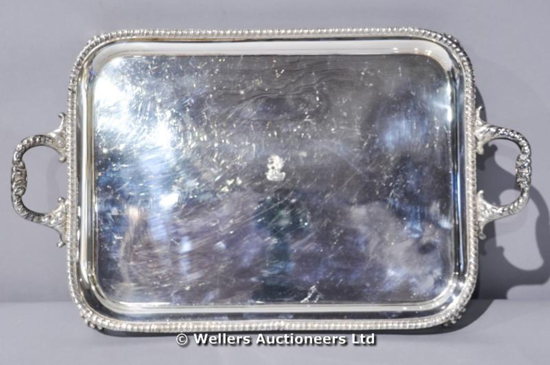 A silver plated two handled tray on four paw feet, C1920