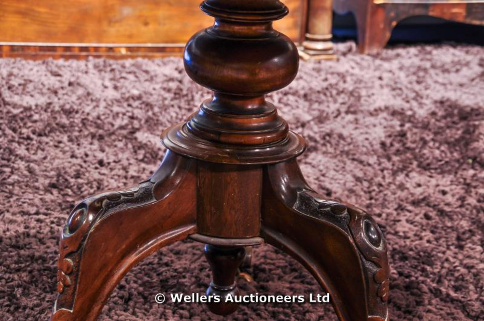 A mahogany tilt top table sitting on turned pedestal with carved tripod legs and original castors, - Image 2 of 8