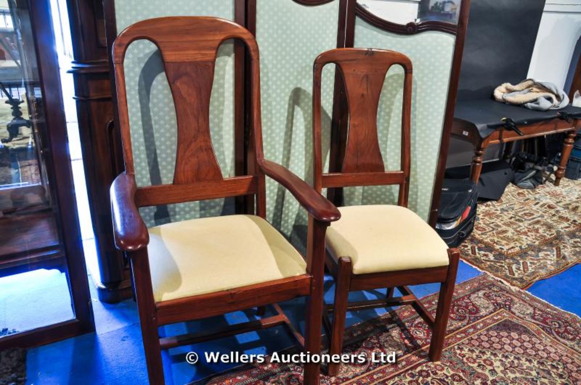 A set of Ten African Teak dining chairs including two carvers