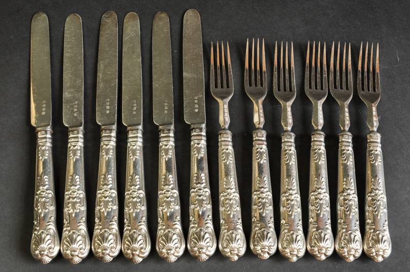 A white metal fruit service with close plated blades, six knives and forks