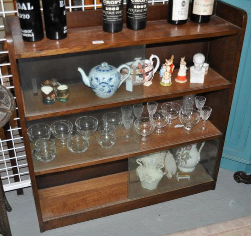 A 20thC glass cabinet, the two sliding doors enclosing shelves, 92 x 93 x 22cm