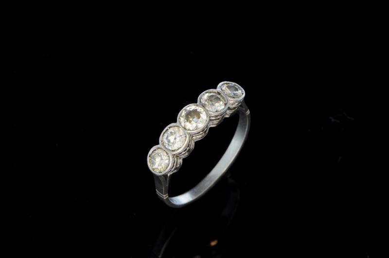 Old cut diamond five stone ring, five rubover set old cut diamonds, mounted in white metal tested as