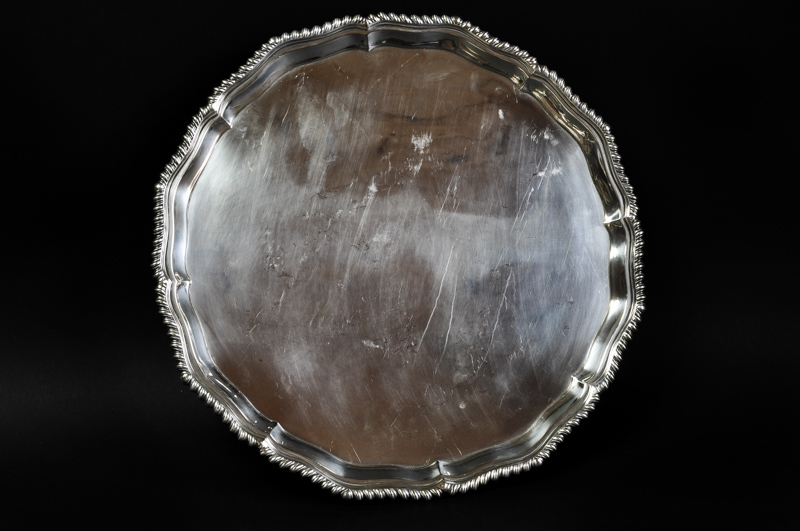A large circular silver salver with gadrooned edge, claw and ball feet, Sheffield 1901, 1390grs