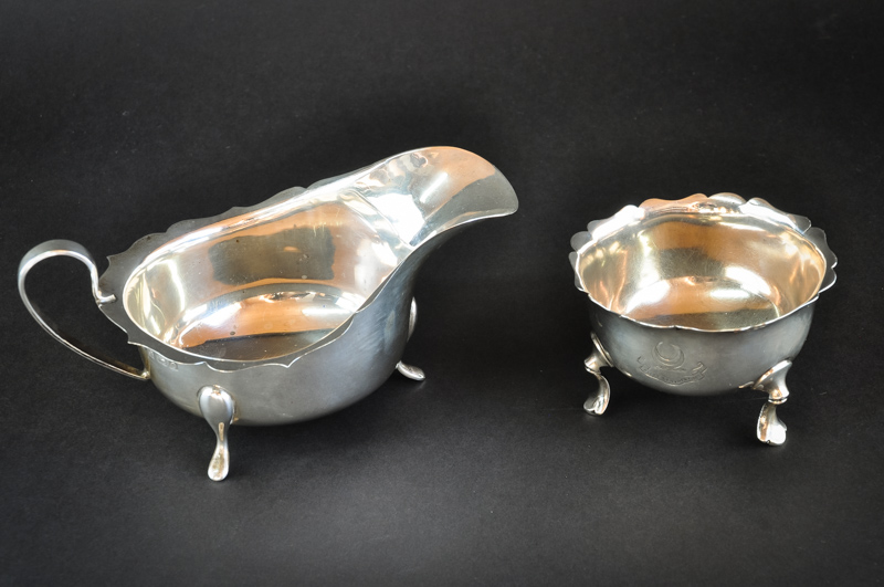 A silver sauce boat, Birmingham 1913, by Barker Bros; and a silver tri-foot sugar bowl, Sheffield,