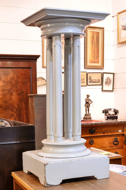 A grey painted four column torchere stand