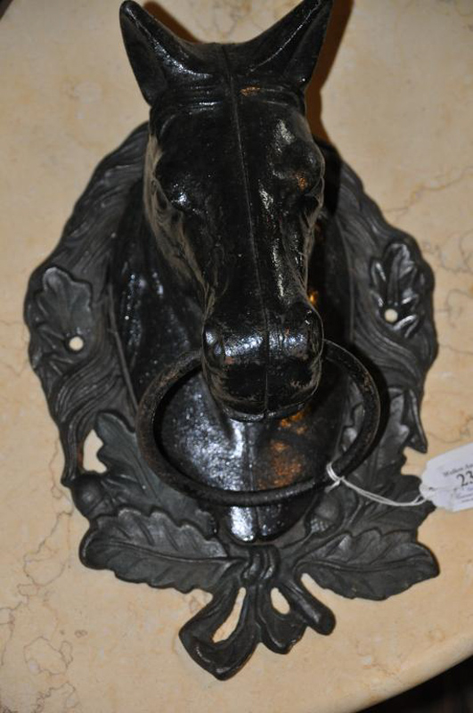 A cast iron bridle hitch in the form of a horse`s head