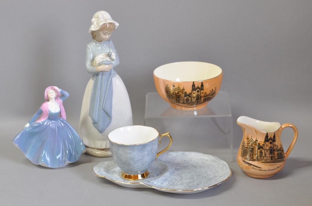 A Coalport figure, `Vicki`; a Nao figure of a young girl with a puppy; a Royal Albert duo, `