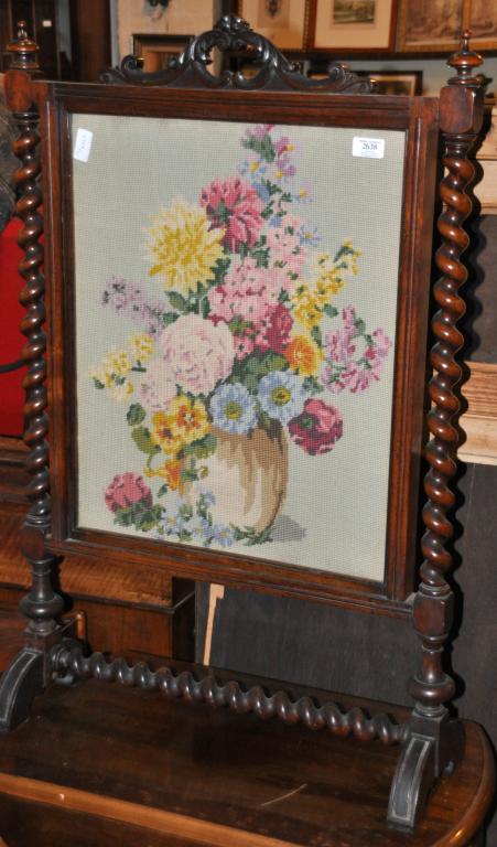 A Victorian rosewood framed firescreen with woolwork panel. 93cm high.