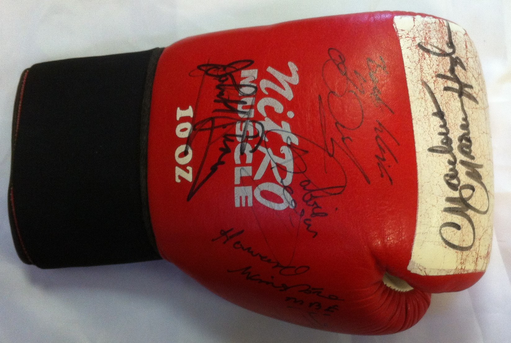 BOXING: A red and white Nitro Muscle boxing glove individually signed by seven boxers, some of them