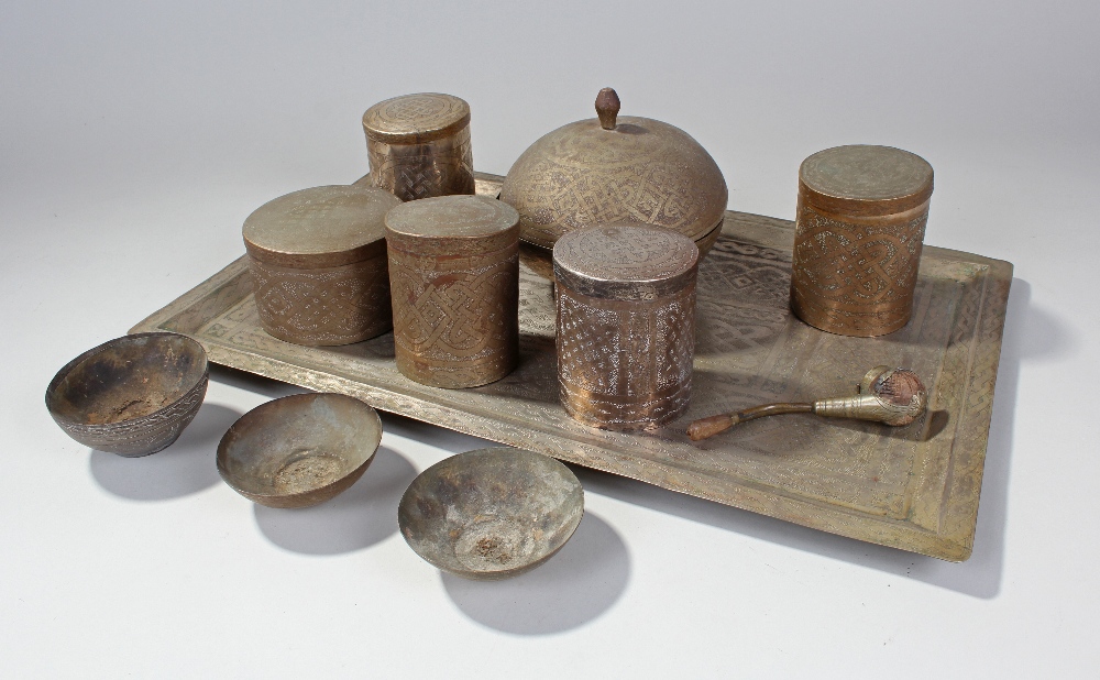 Quantity of eastern metalware comprising of tray, six pots with lids etc., all with engraved