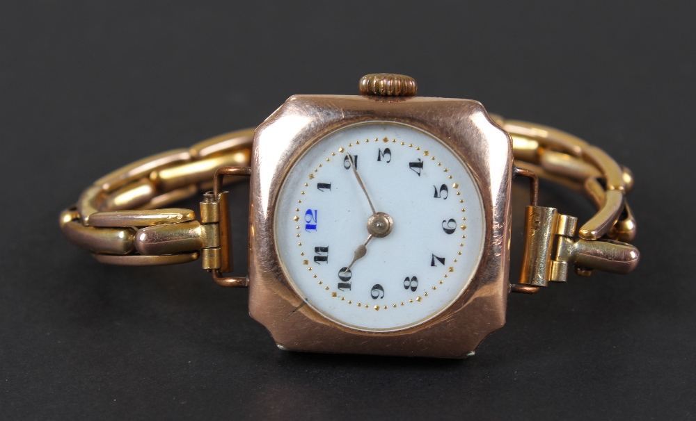 9 carat gold ladies wristwatch, the white enamel dial having black arabic numerals, bordered by a