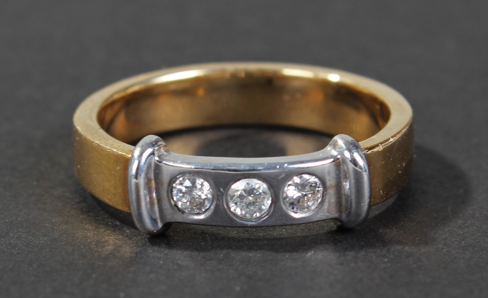 18 carat gold diamond set ring, the platinum head set with a row of three brilliant cut diamonds,