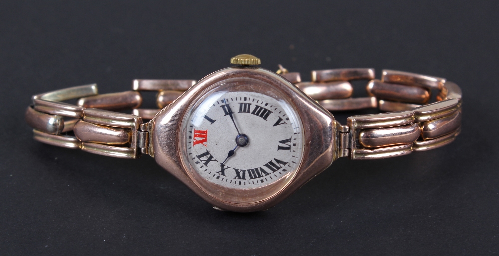 9 carat gold ladies wristwatch, the silvered dial having black roman numerals, bordered by a