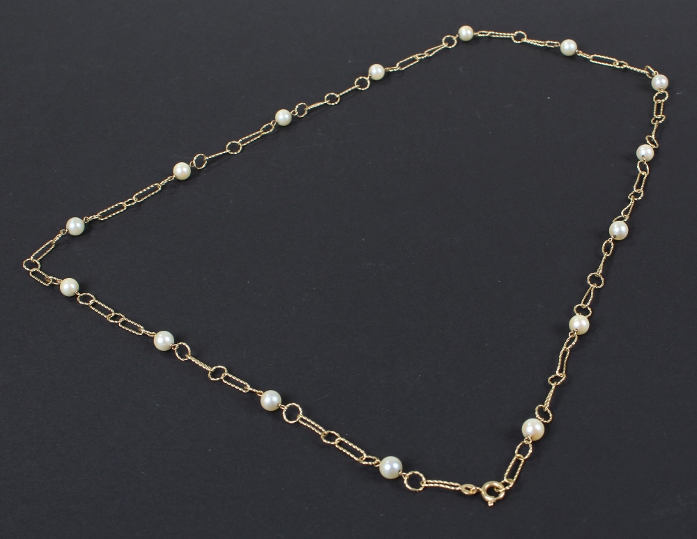 18 carat gold pearl set necklace, having open links and set with fifteen pearls, 18 grams