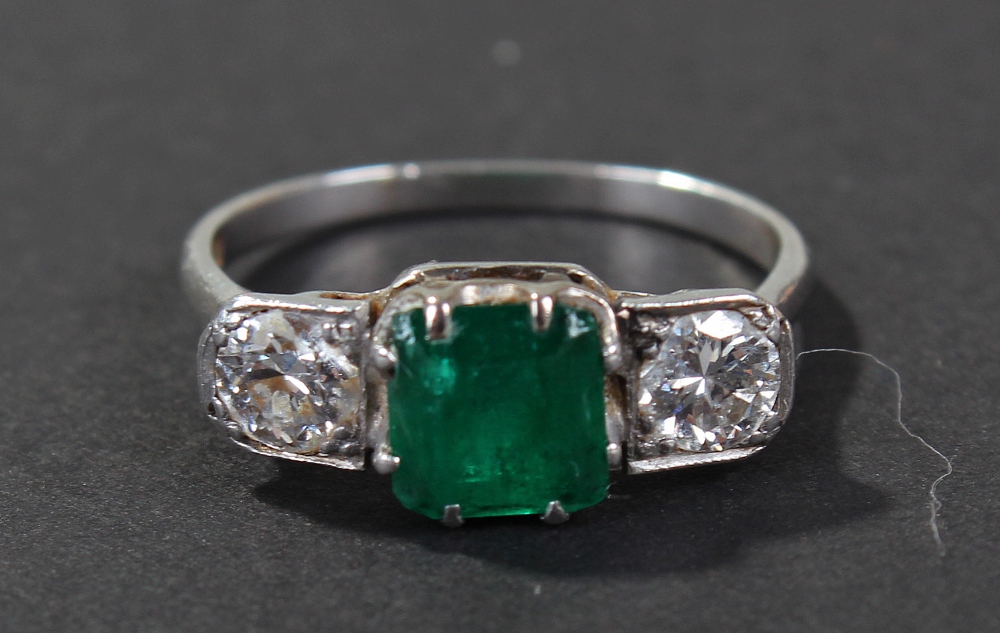 Art Deco platinum diamond and emerald set ring, the head centered with square cut emerald, flanked