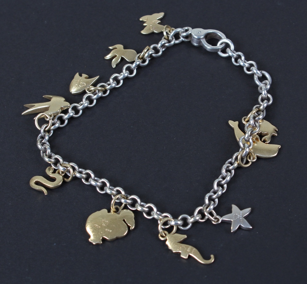 Pomellato 18 carat white gold charm bracelet, hung with nine 18 carat gold charms and an 18 carat