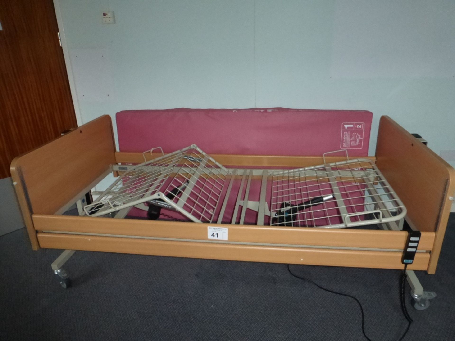 An AKS electrically operated adjustable nursing bed serial number: 91663, with a soft form