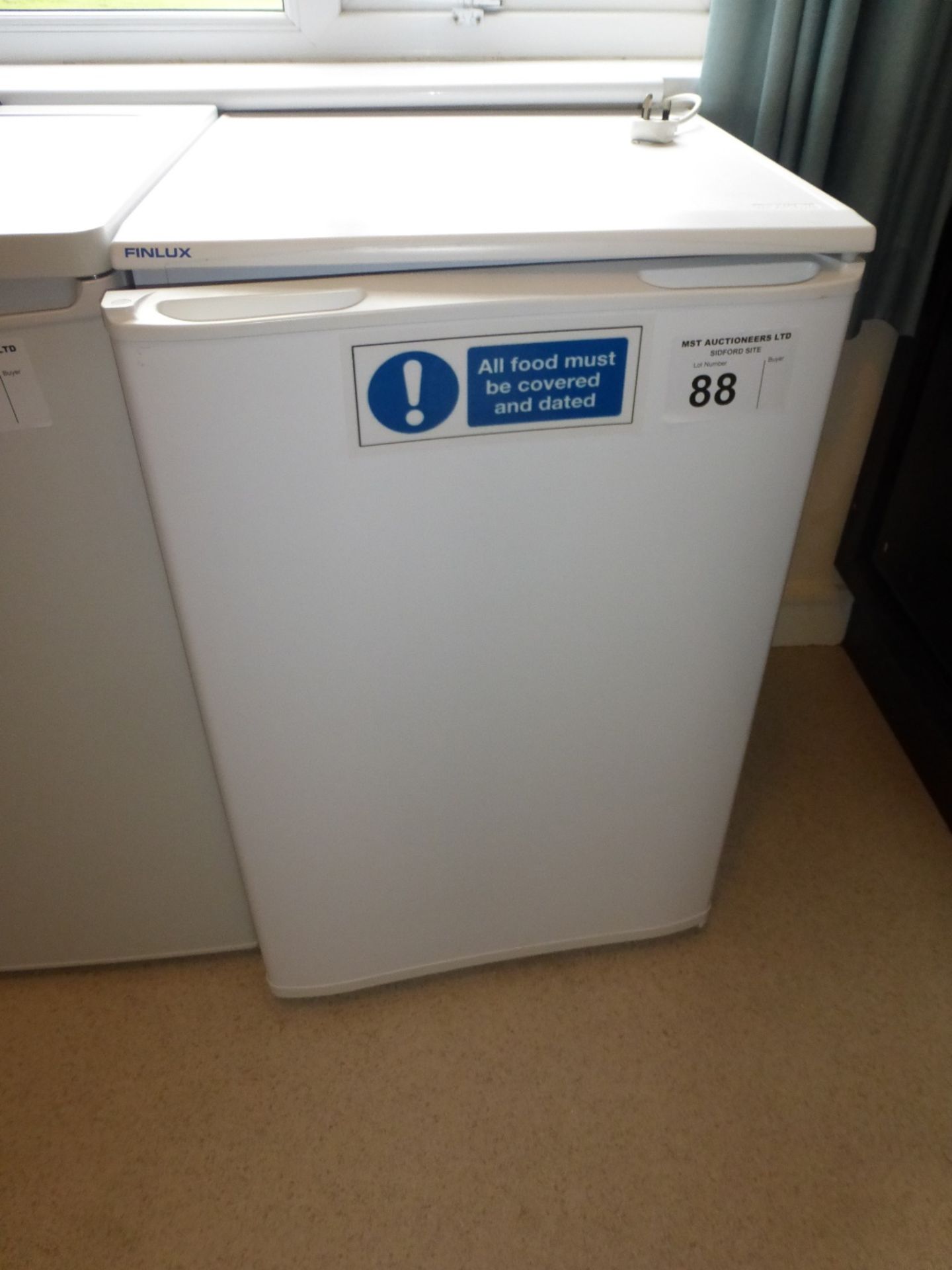 A Finlux under counter refrigerator (located in room 30)