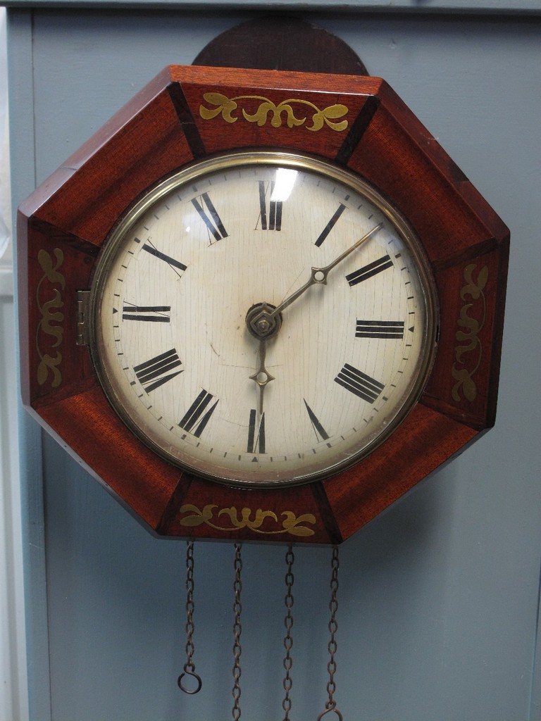 19TH CENTURY BRASS INLAID MAHOGANY OCTAGONAL SHAPED WALL CLOCK with painted face and two train