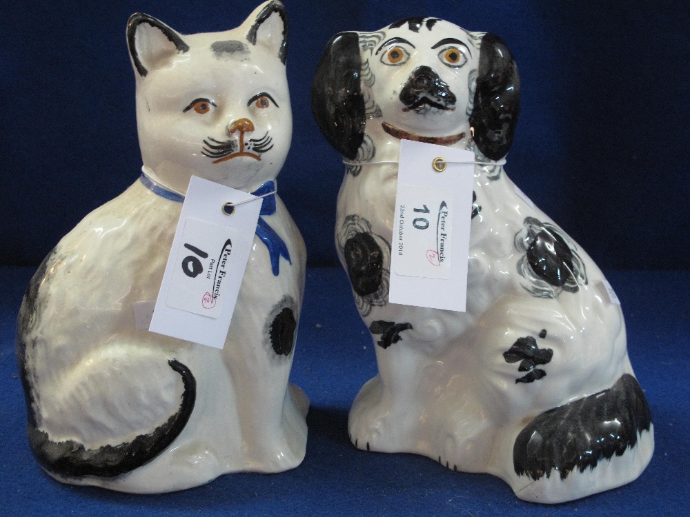 Staffordshire pottery black and white seated spaniel together with companion, similar seated cat. (