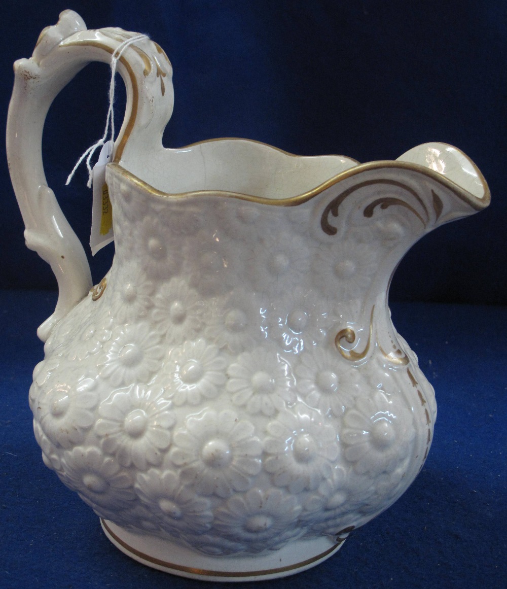 19th Century Welsh Pottery daisy head relief moulded baluster shaped jug with gilded highlights.