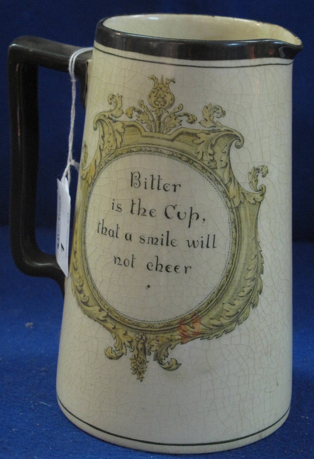 Royal Doulton pottery tapering cylinder jug with inscriptions "Bitter is the cup that a smile will