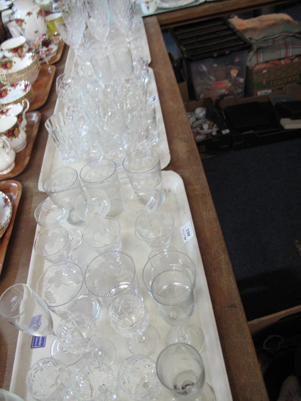 Three trays of assorted drinking vessels to include star hobnail cut design wine glasses,