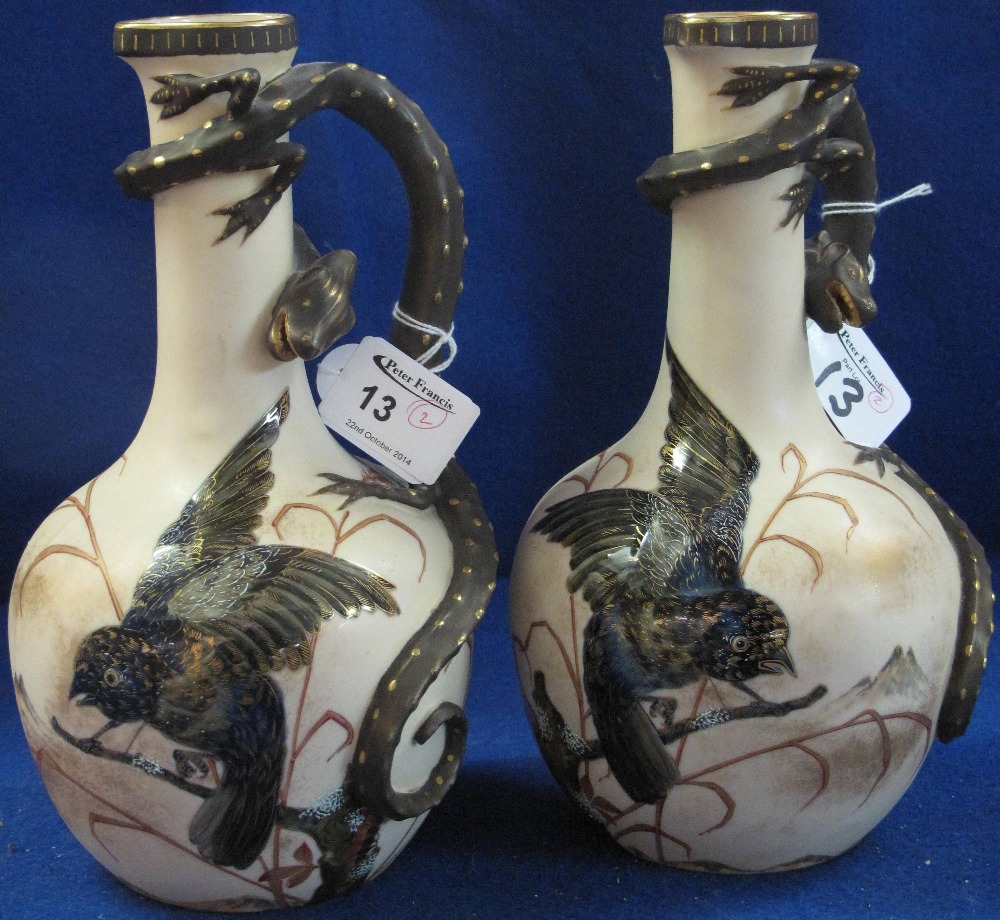 Pair of 19th Century ivory ground bottle shaped ewers, enamel painted with bird amongst foliage