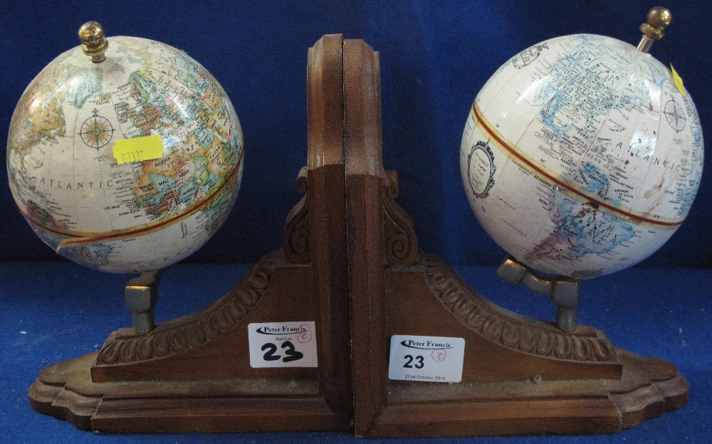 Pair of modern wooden book ends with world globes thereon. (2)