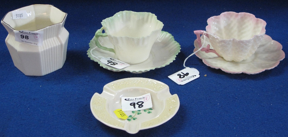 Four items of Belleek porcelain to include shamrock ashtray with green printed marks, octagonal