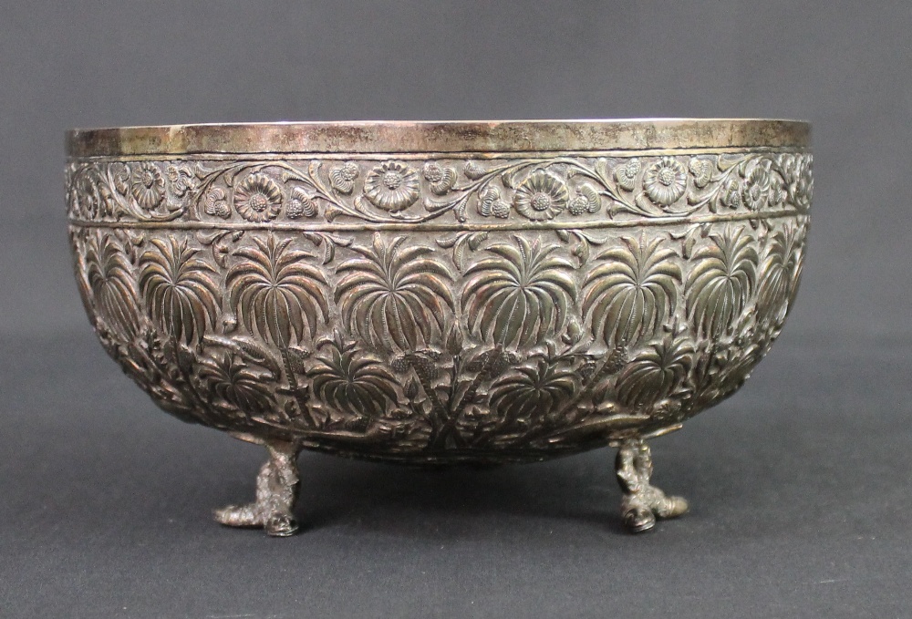 A BURMESE SILVER BOWL, repousse decorated with various animals including an Elephant, Tiger, Rhino