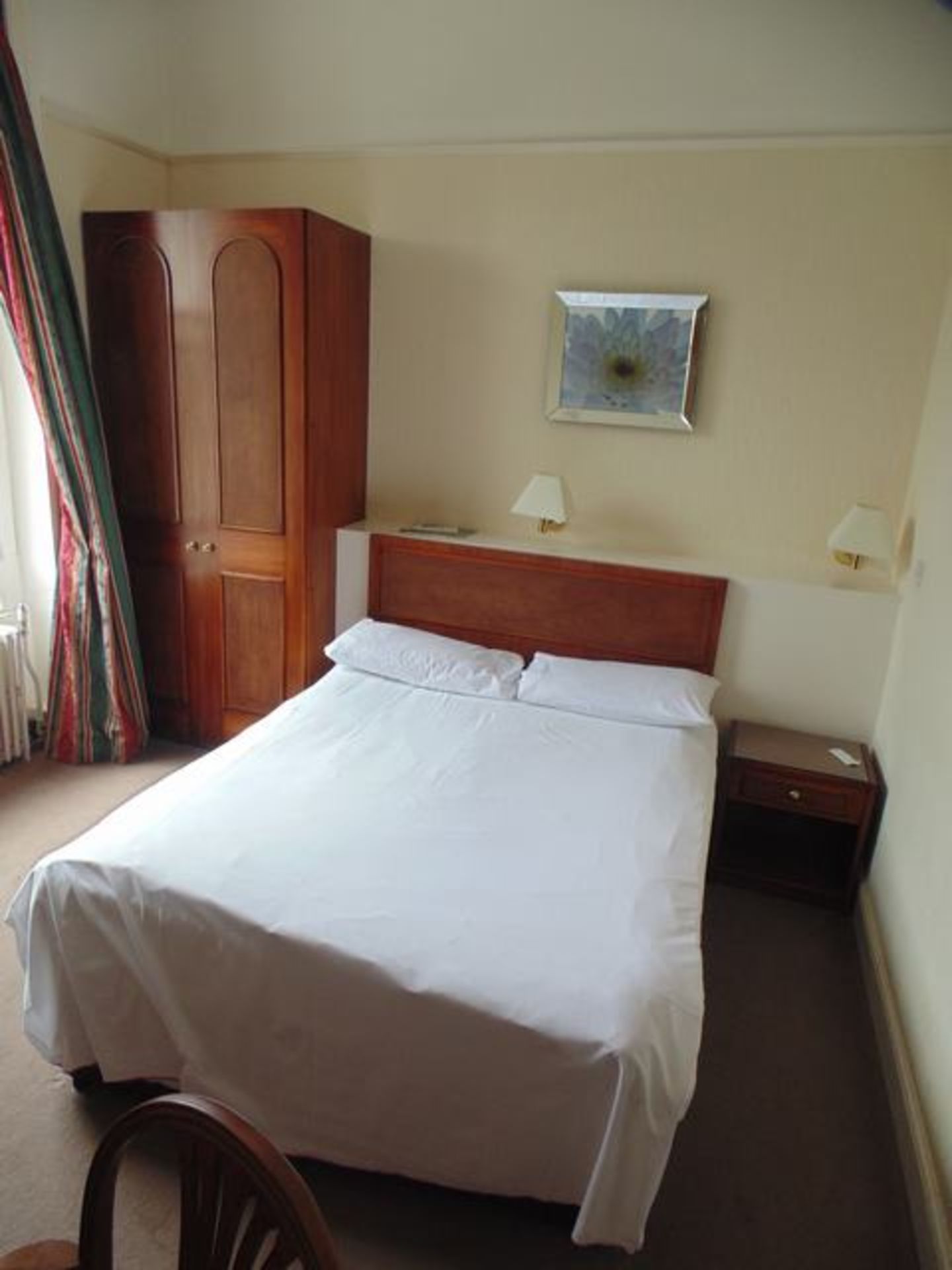 Content of Room 15 comprising of double bed and headboard, nightstand, wardrobe, desk and chair,