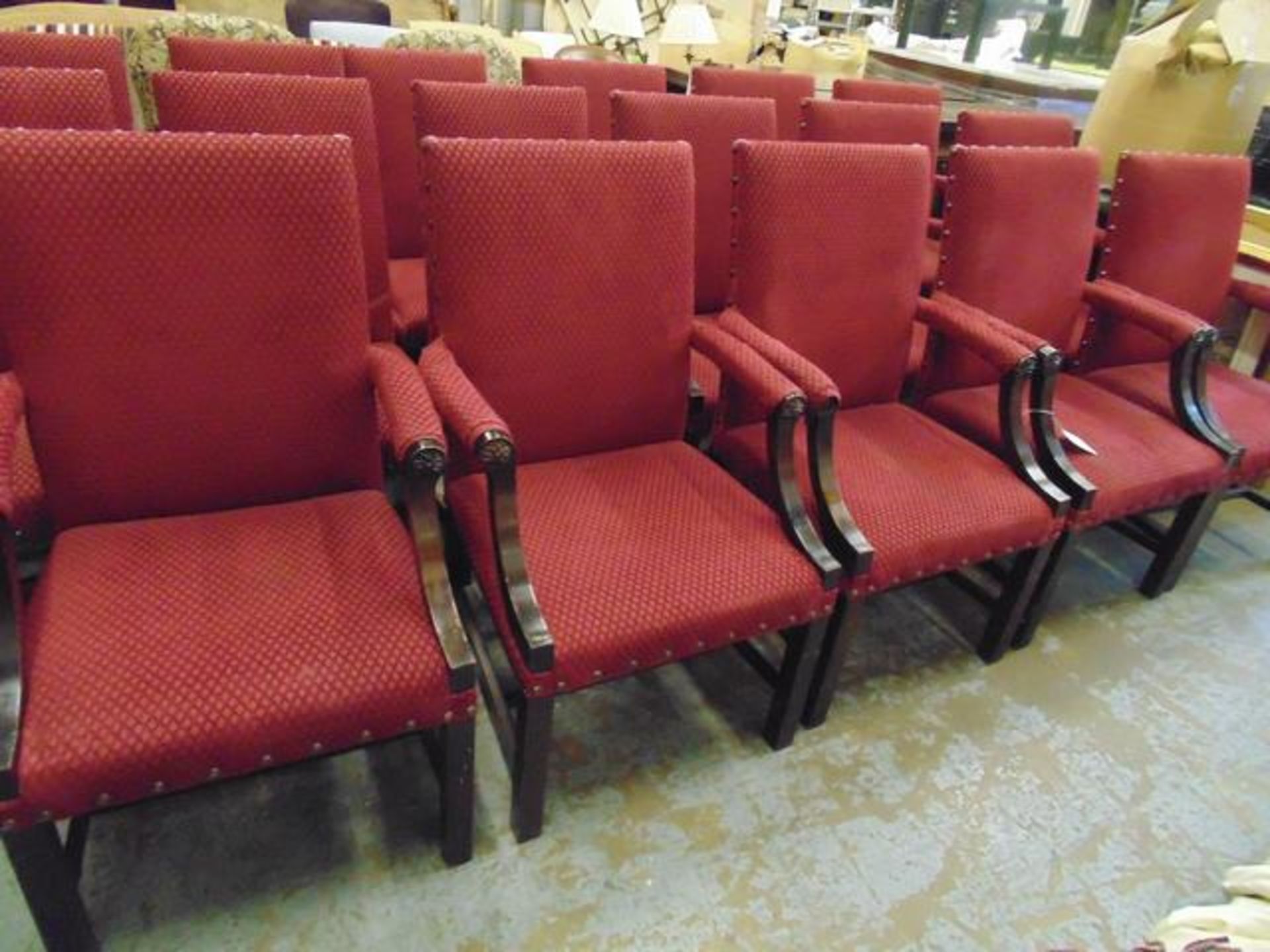 A set of four Windsor upholstered carver chairs upholstered in red fabric with stud button finish