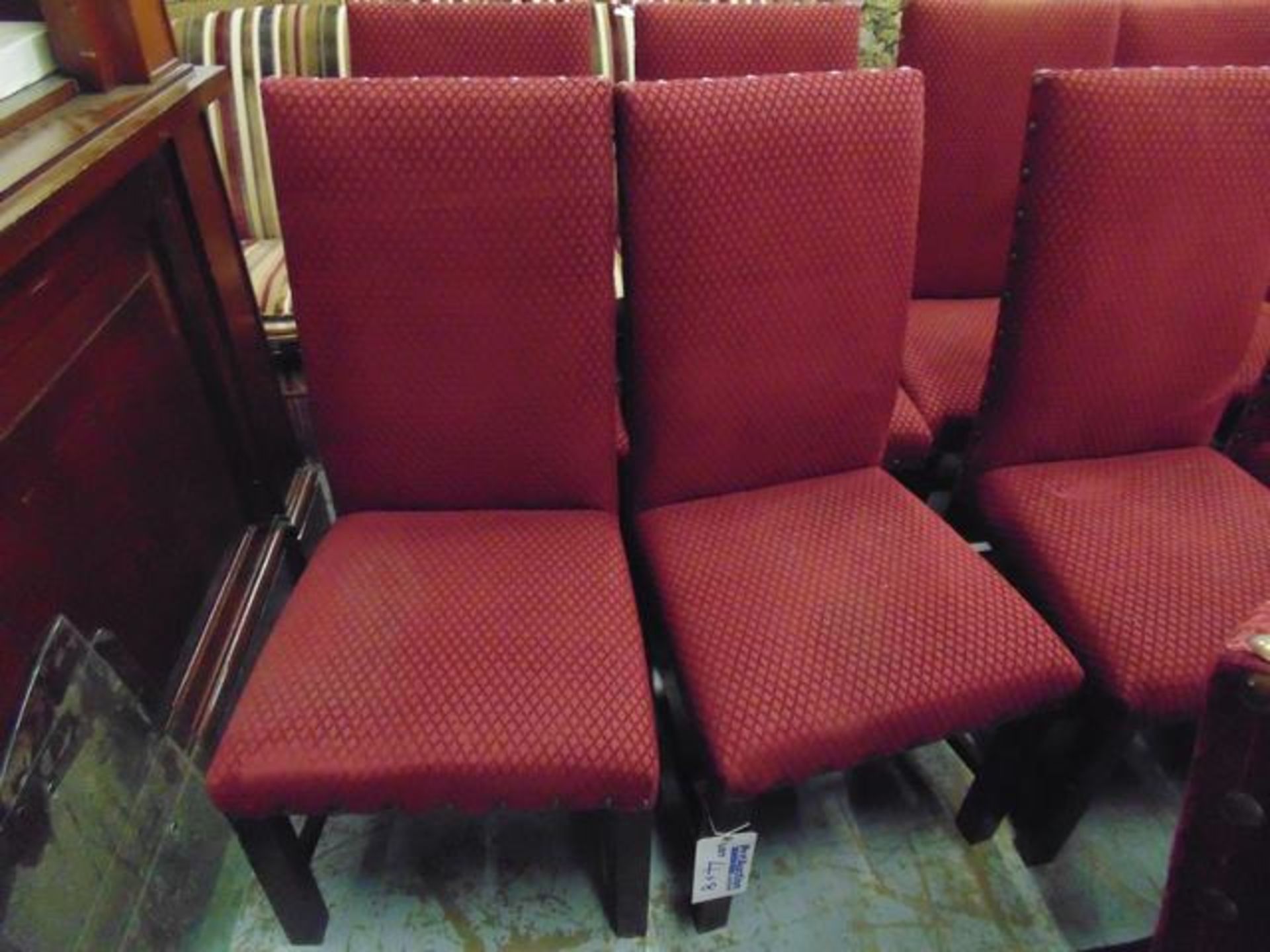 A set of eight Windsor upholstered side chairs upholstered in red fabric with stud button finish