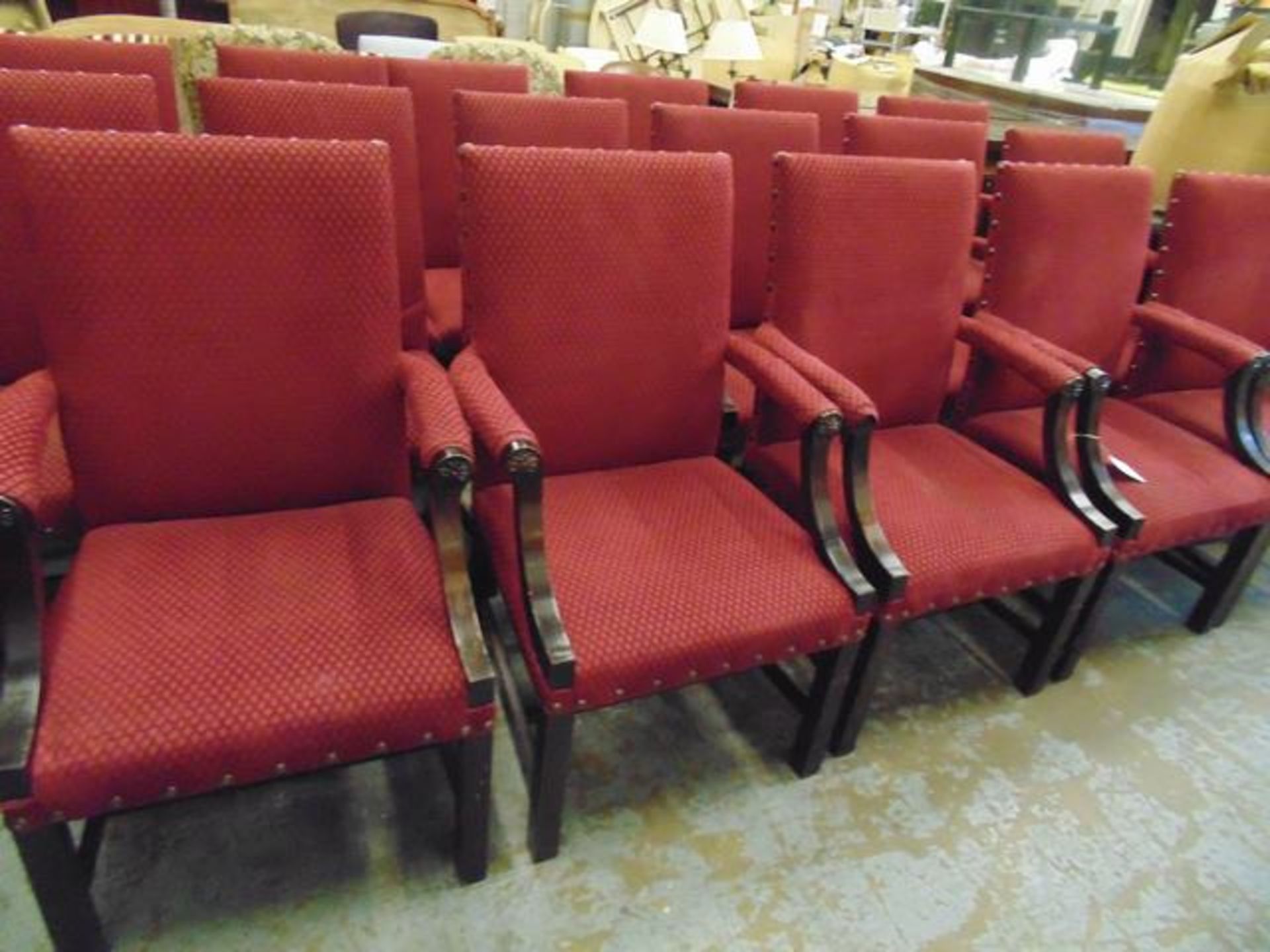 A set of four Windsor upholstered carver chairs upholstered in red fabric with stud button finish