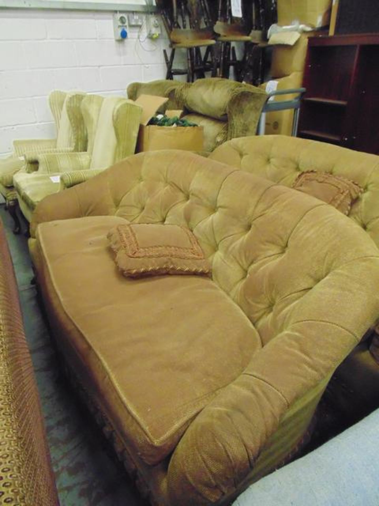A pair of gold upholstered two seater sofas
