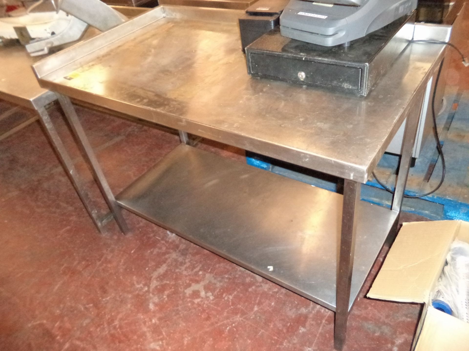 Stainless steel twin tier table with splash backs on 2 sides, circa 1.2m wide x circa 6.75cm