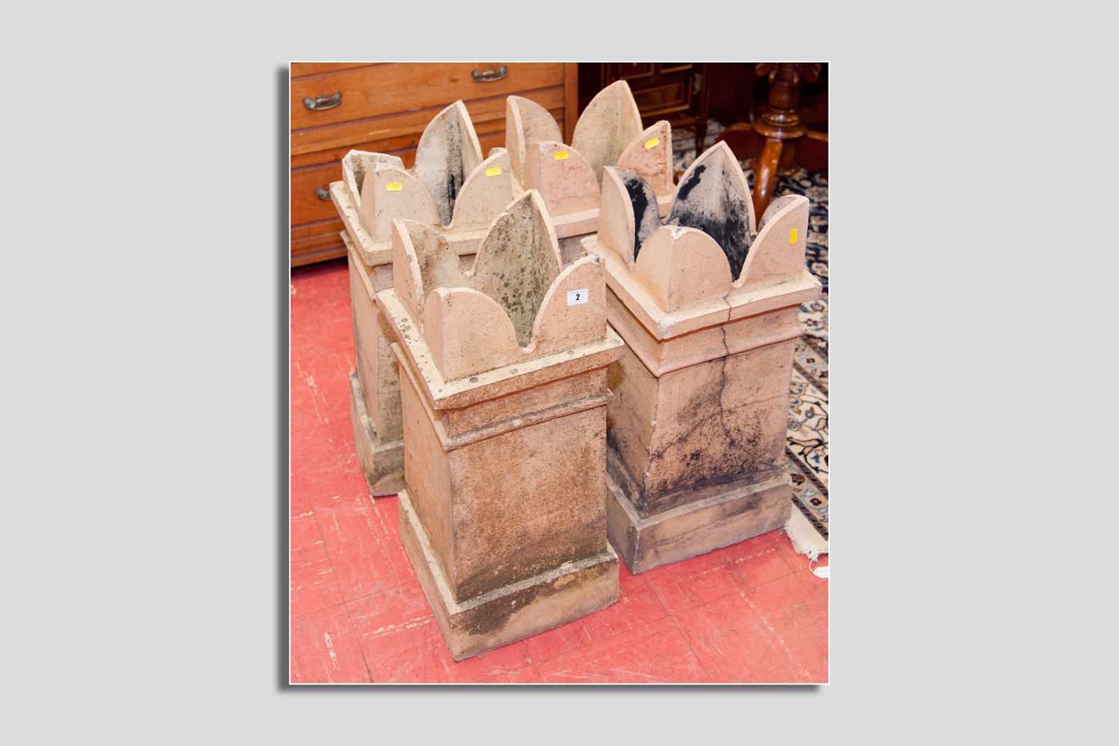 Four sandstone crown top chimney pots, 27 x 12 ins (68 x 30 cms), (some damage and losses to all)