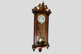 A late 19th Century eight day twin weight driven walnut encased Vienna regulator wall clock having
