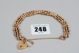A nine carat gold three bar bow basket bracelet with bright cut nine carat gold padlock and safety