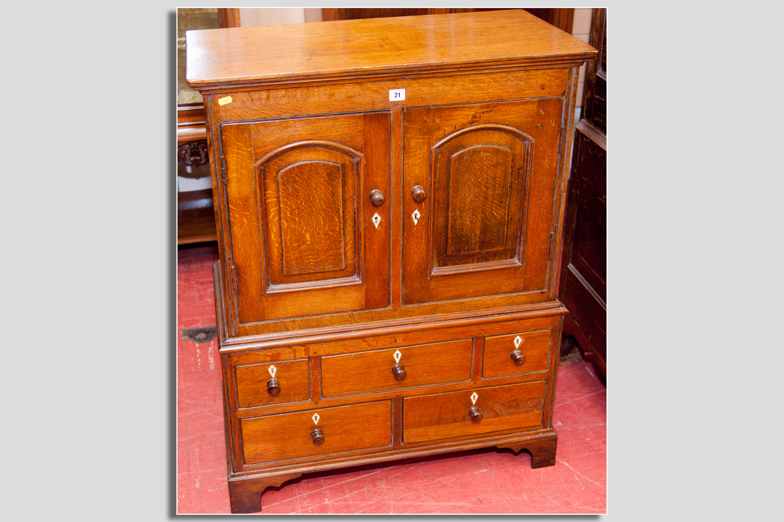 A fine antique oak miniature two piece press cupboard, the upper section having twin doors with