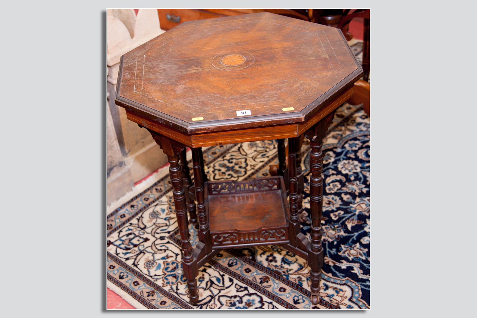 An Edwardian octagonal rosewood occasional table having four double turned supports to a square