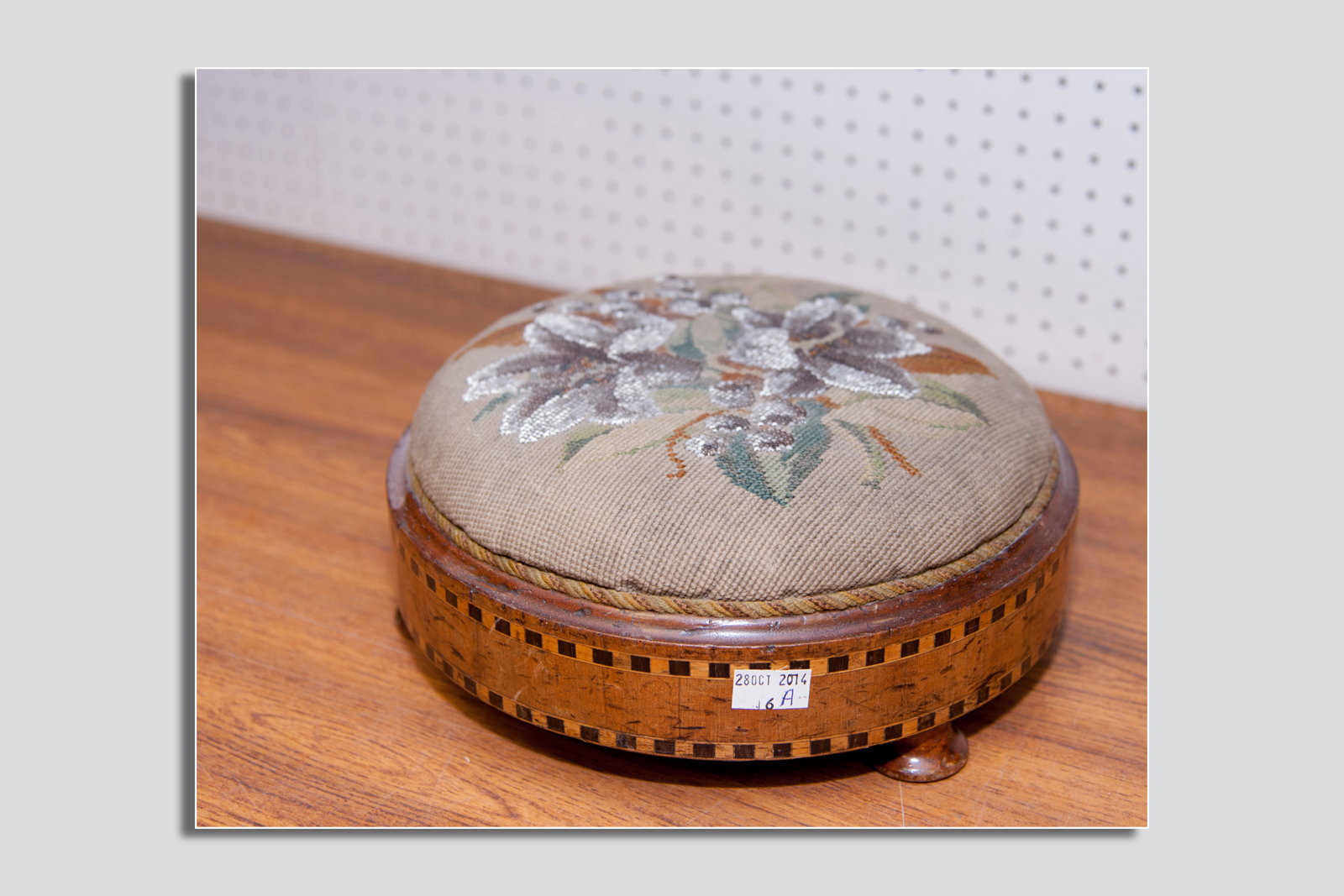 A Victorian walnut beadwork top boxwood inlaid footstool, 11 ins (28 cms)