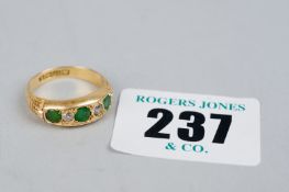 An eighteen carat gold diamond (two) and emerald (three) half hoop dress ring, 4.5 grms gross
