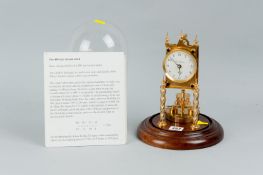 A brass four hundred day torsion clock with anchor escapement movement standing on two twist brass